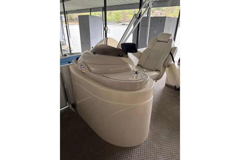 Slide: The Image of 2007 Crest 2570 III XRS boat helm with captain's chair under covered dock. - 14