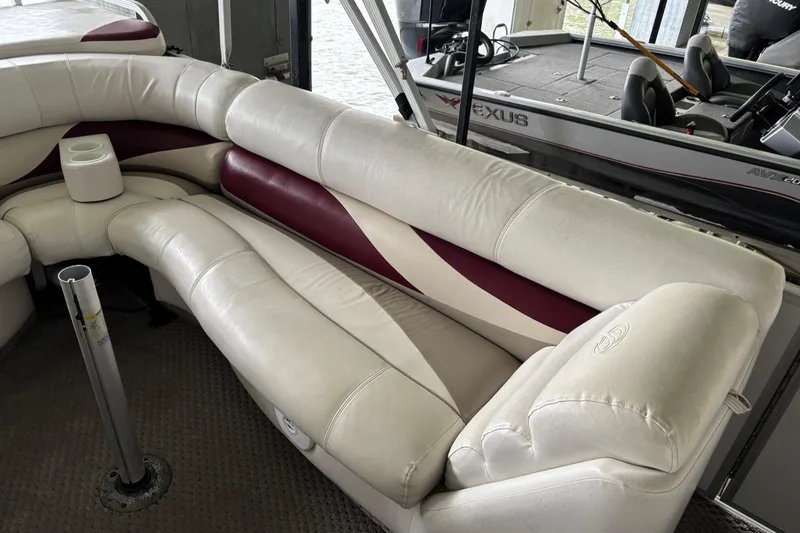 Slide: The Image of Luxurious seating on a 2007 Crest 2570 III XRS boat with white and maroon upholstery. - 19
