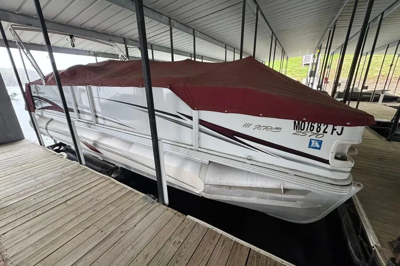 Slide: The Image of 2007 Crest 2570 III XRS pontoon boat docked with maroon cover. - 2
