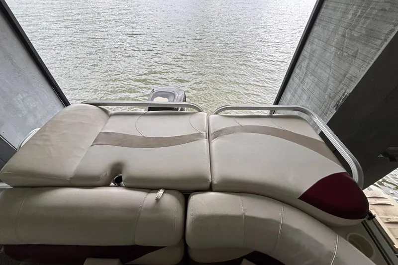 Slide: The Image of Crest 2570 III XRS 2007 boat interior with cushioned seating overlooking water. - 21