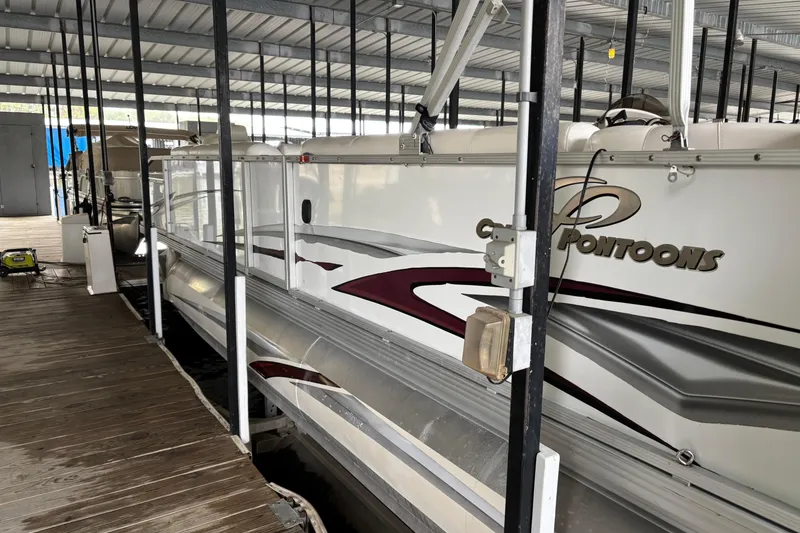 Slide: The Image of 2007 Crest 2570 III XRS pontoon boat docked in a covered marina. - 4