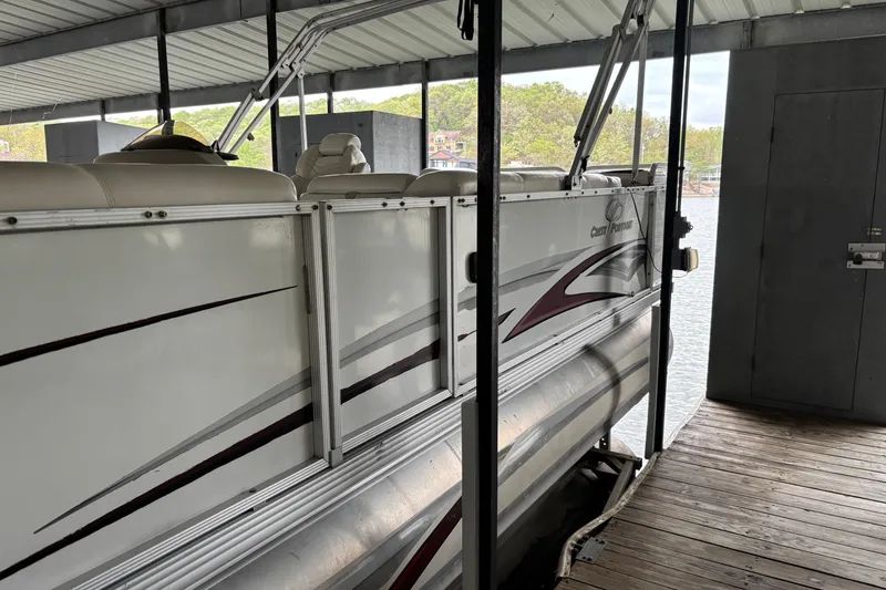 Slide: The Image of 2007 Crest 2570 III XRS pontoon boat docked under covered marina. - 5