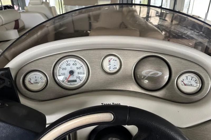 Slide: The Image of Dashboard of a 2007 Crest 2570 III XRS boat with gauges and steering wheel. - 9