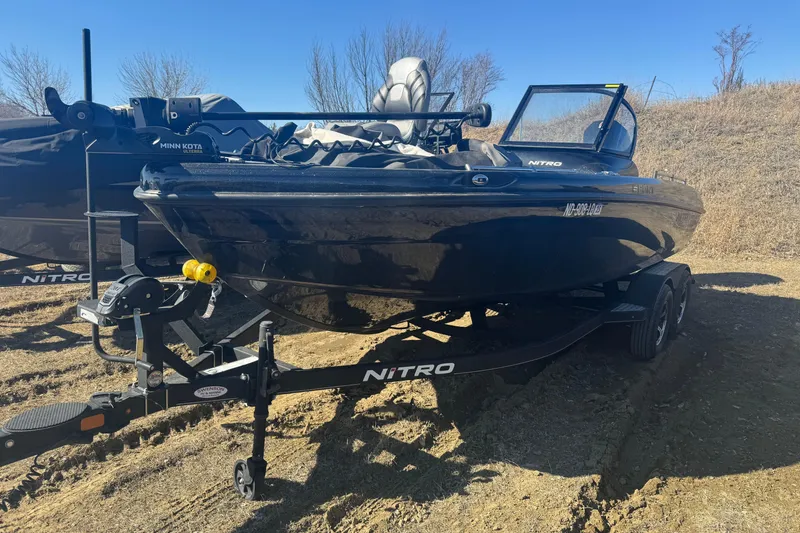 The Image of 2021 Nitro ZV19 Sport boat on trailer, parked on grassy terrain. - 1