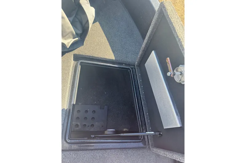 Slide: The Image of 2021 Nitro ZV19 Sport boat storage compartment with carpeted interior and hydraulic lift. - 14