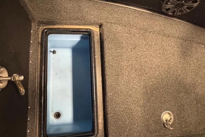 Slide: The Image of Interior storage compartment of 2021 Nitro ZV19 Sport boat, featuring a blue interior. - 20
