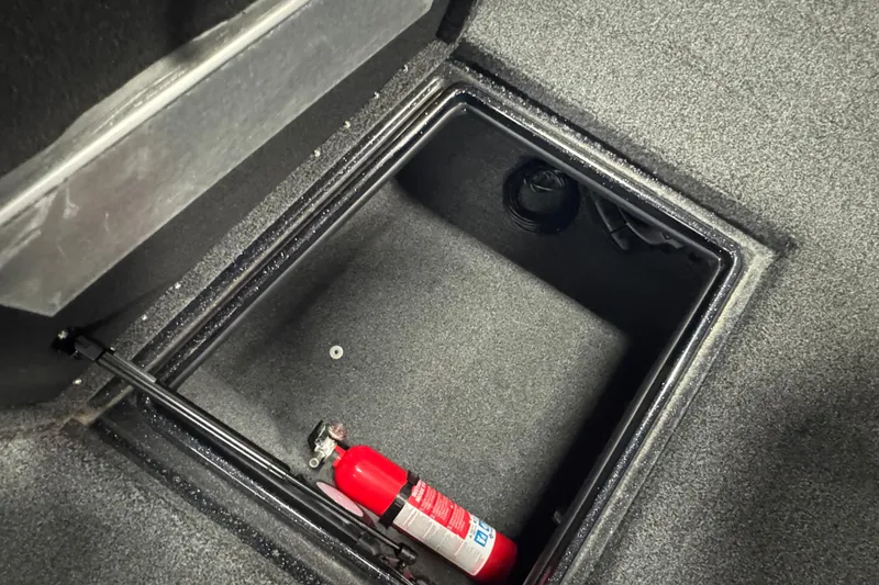 Slide: The Image of Storage compartment in 2021 Nitro ZV19 Sport boat with fire extinguisher. - 21