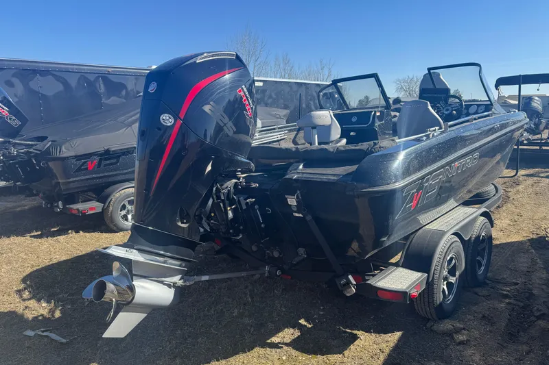 Slide: The Image of 2021 Nitro ZV19 Sport boat with powerful outboard motor, parked on a trailer. - 3