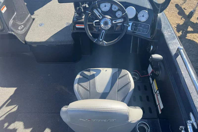 Slide: The Image of 2021 Nitro ZV19 Sport boat cockpit with steering wheel and dashboard controls. - 5