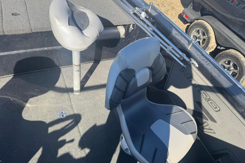 Slide: The Image of 2021 Nitro ZV19 Sport boat interior with two gray seats and visible branding. - 8