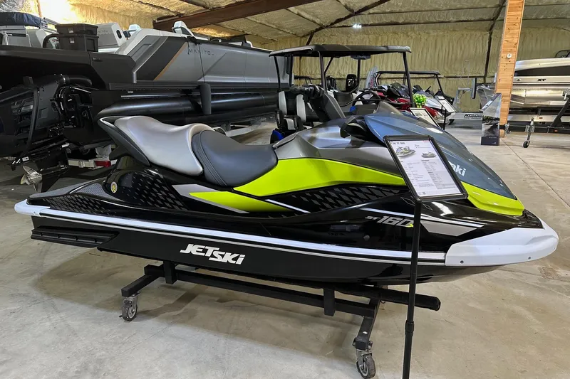 The Image of 2026 Kawasaki ST 160X jet ski in showroom, featuring sleek design and vibrant colors. - 0