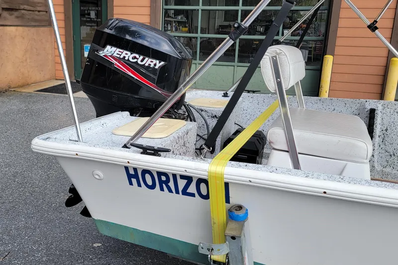 Slide: The Image of 2021 HORIZEN CS 170 CC boat with Mercury engine, parked outside a building. - 4