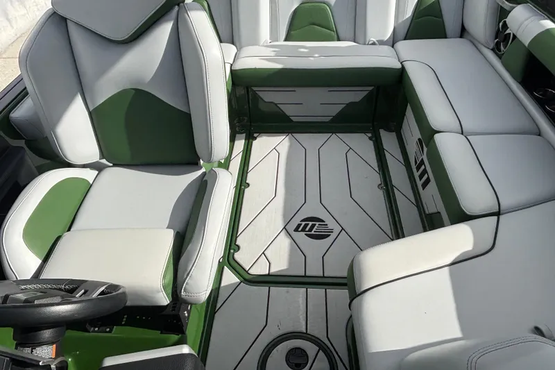 Slide: The Image of Interior of 2021 Malibu Wakesetter 21 VLX boat with green and white seating. - 10