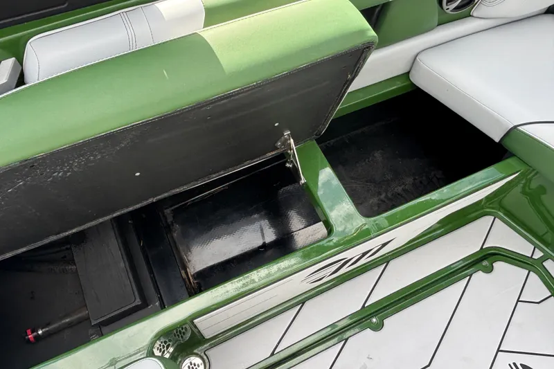 Slide: The Image of 2021 Malibu Wakesetter 21 VLX interior storage compartment with green and white seating. - 11