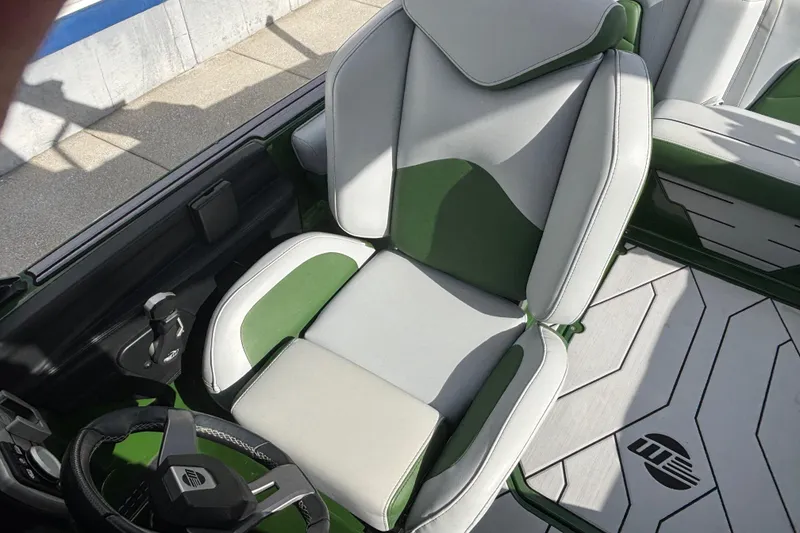 Slide: The Image of 2021 Malibu Wakesetter 21 VLX interior with green and white seating and steering wheel. - 13