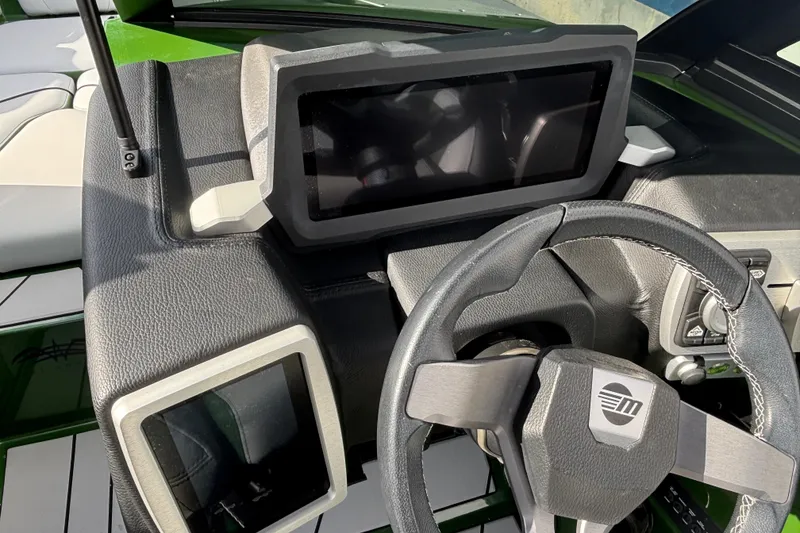 Slide: The Image of 2021 Malibu Wakesetter 21 VLX dashboard with modern steering and digital displays. - 14