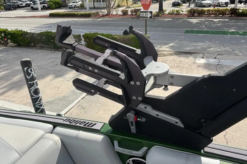 Slide: The Image of 2021 Malibu Wakesetter 21 VLX boat with a wakeboard rack in a parking area. - 15