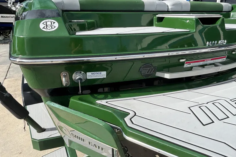 Slide: The Image of 2021 Malibu Wakesetter 21 VLX boat, green exterior, rear view with swim platform. - 4