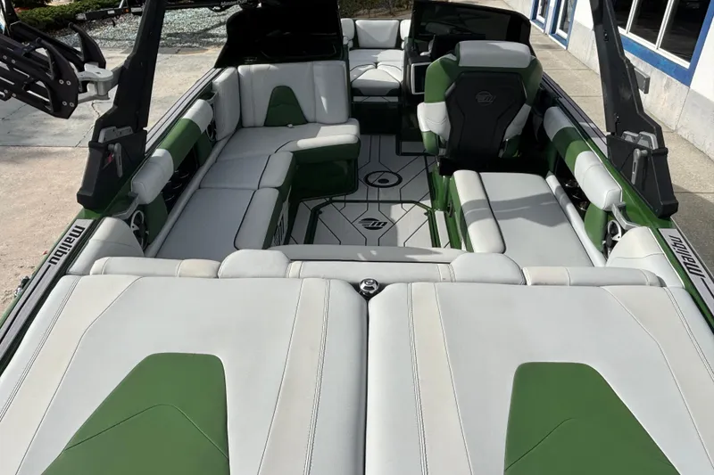 Slide: The Image of 2021 Malibu Wakesetter 21 VLX interior with green and white seating, spacious layout. - 5