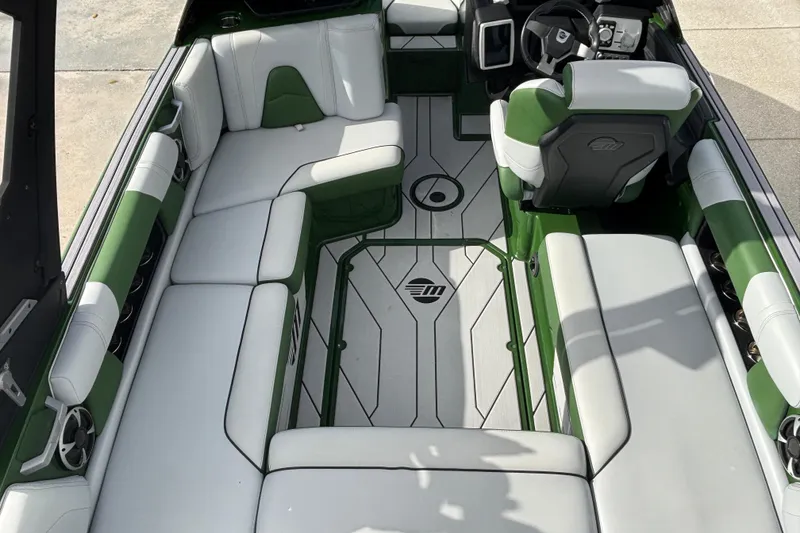 Slide: The Image of 2021 Malibu Wakesetter 21 VLX interior with green and white seating, modern dashboard. - 6