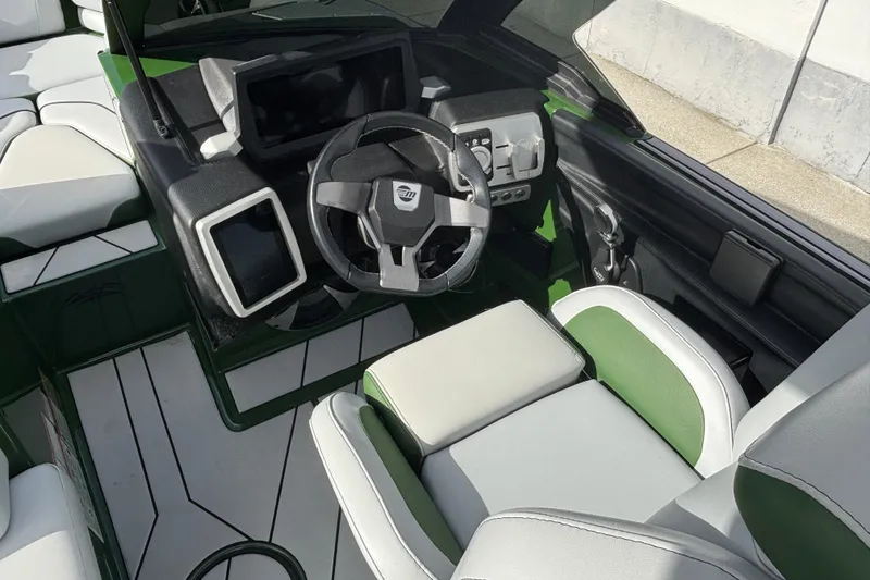 Slide: The Image of 2021 Malibu Wakesetter 21 VLX boat interior with modern dashboard and green accents. - 7