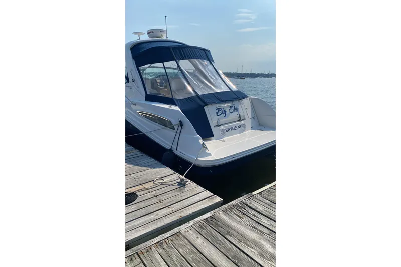 Slide: The Image of 2012 Sea Ray Sundancer 350 docked, rear view with "Big Sky" name visible. - 3