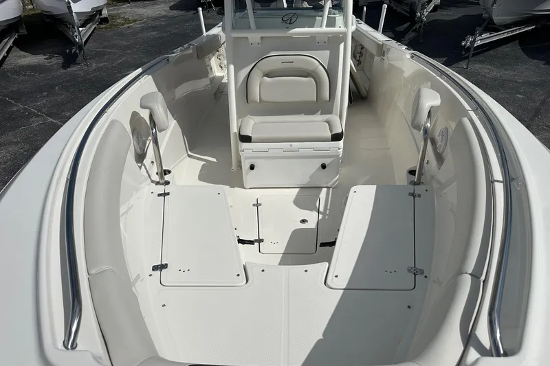 Slide: The Image of 2022 Sailfish 290 CC boat interior with spacious seating and storage compartments. - 14