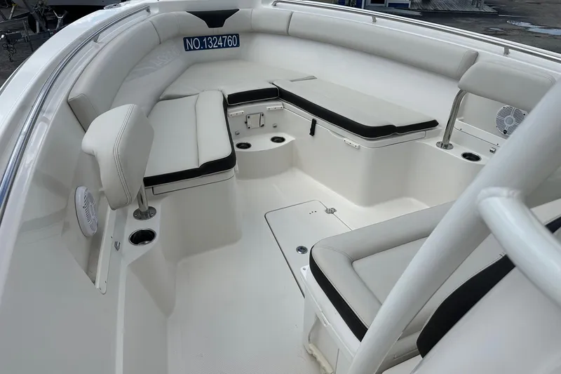 Slide: The Image of 2022 Sailfish 290 CC boat interior with cushioned seating and storage compartments. - 15