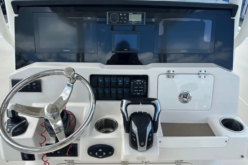 Slide: The Image of 2022 Sailfish 290 CC helm with dual Garmin displays and modern controls. - 23