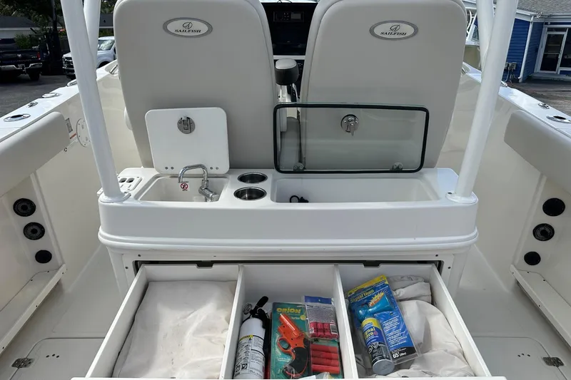 Slide: The Image of 2022 Sailfish 290 CC boat interior with storage compartments and safety equipment. - 29