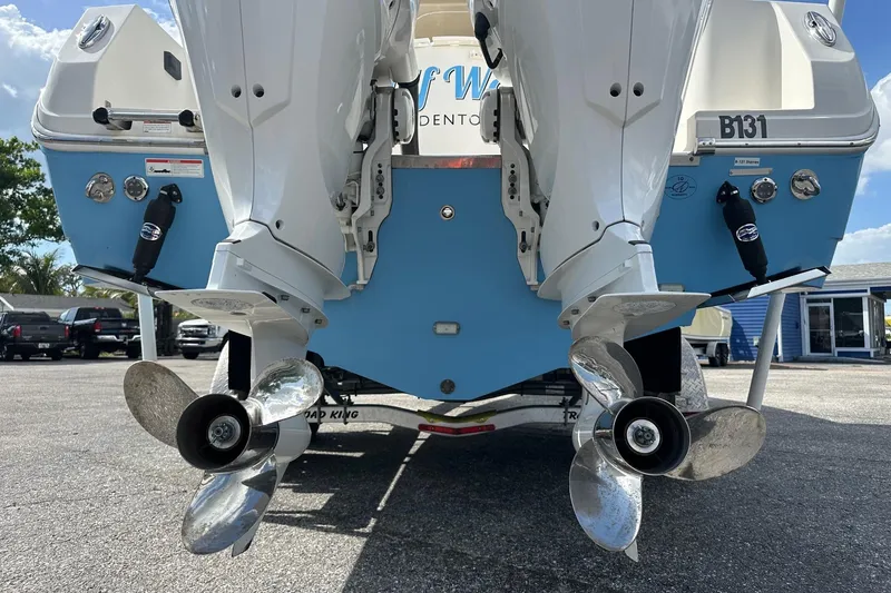 Slide: The Image of 2022 Sailfish 290 CC boat with dual outboard motors and stainless steel propellers. - 3