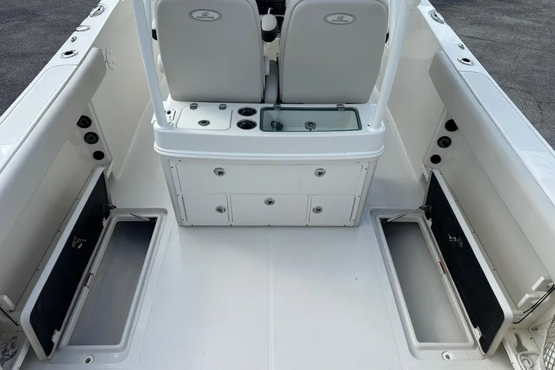 Slide: The Image of 2022 Sailfish 290 CC boat interior with storage compartments and seating. - 31