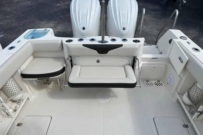 Slide: The Image of 2022 Sailfish 290 CC boat interior with seating and storage compartments. - 32