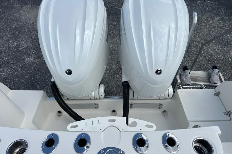 Slide: The Image of Twin Yamaha outboard engines on a 2022 Sailfish 290 CC boat, with fishing rod holders. - 34