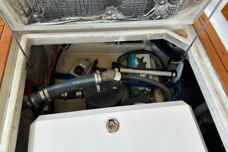 Slide: The Image of Engine compartment of a 1987 Kadey-Krogen Manatee 36 boat, showing hoses and components. - 100