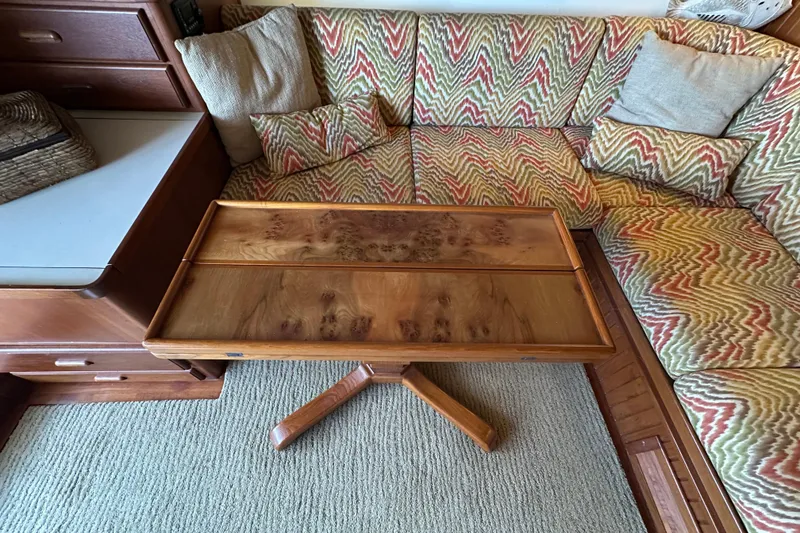 Slide: The Image of Cozy 1987 Kadey-Krogen Manatee 36 interior with patterned cushions and wooden table. - 12