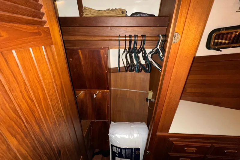 Slide: The Image of Wooden closet interior on a 1987 Kadey-Krogen Manatee 36 boat with hangers. - 53
