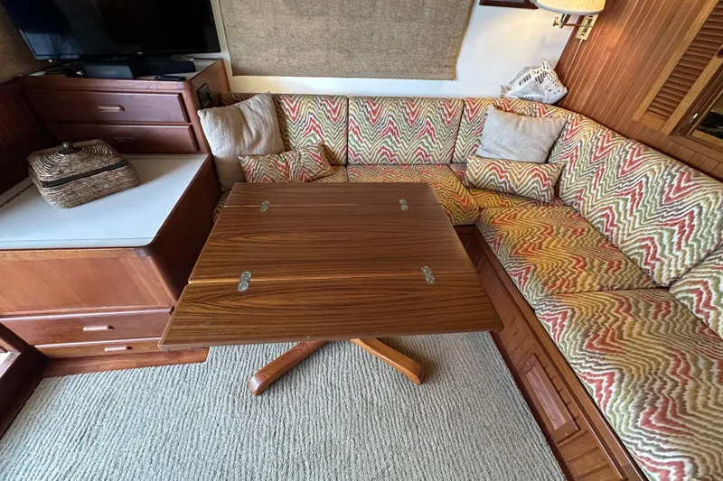 Slide: The Image of Interior of 1987 Kadey-Krogen Manatee 36 with patterned seating and wooden table. - 11
