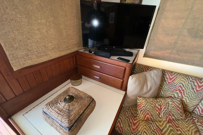 Slide: The Image of Cozy interior of 1987 Kadey-Krogen Manatee 36 with TV, patterned cushions, and wicker decor. - 22