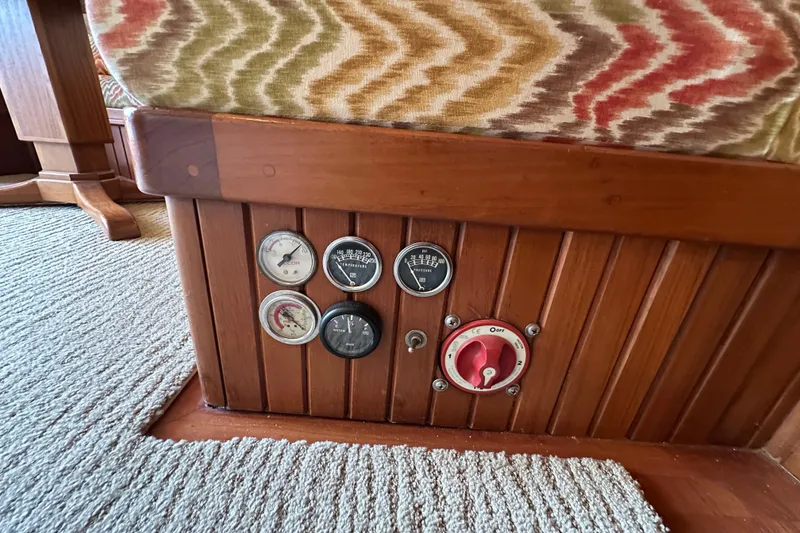 Slide: The Image of 1987 Kadey-Krogen Manatee 36 interior with gauges and control panel on wooden paneling. - 25