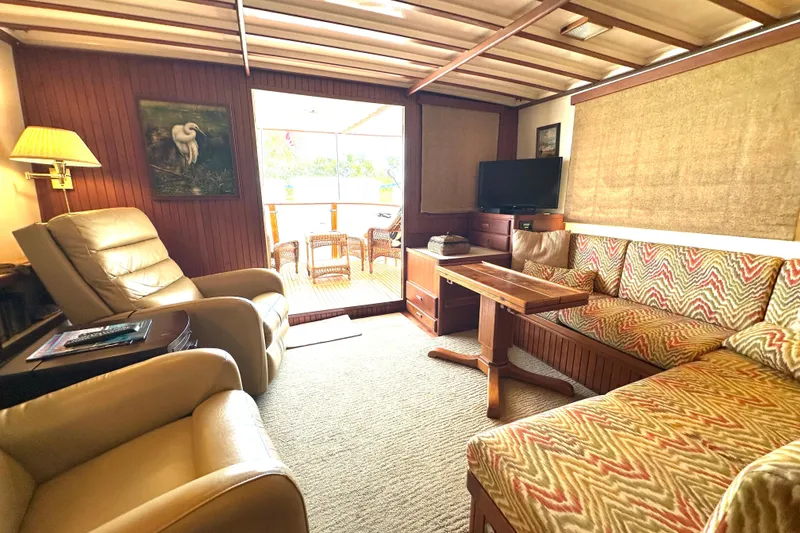 Slide: The Image of Cozy interior of 1987 Kadey-Krogen Manatee 36 with seating, TV, and natural light. - 29
