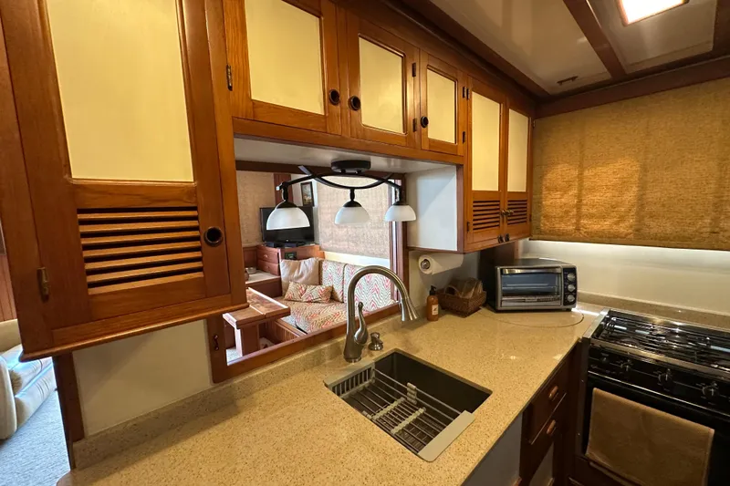 Slide: The Image of 1987 Kadey-Krogen Manatee 36 yacht kitchen with wood cabinets and modern appliances. - 31