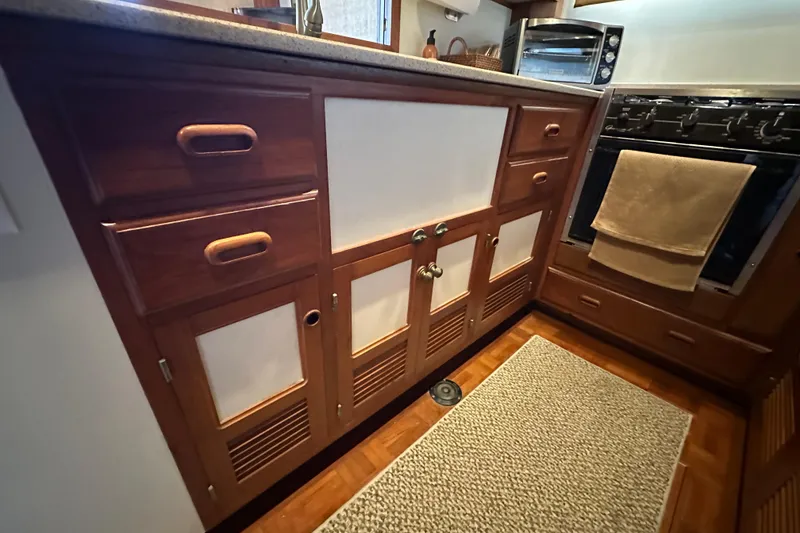 Slide: The Image of 1987 Kadey-Krogen Manatee 36 galley with wooden cabinetry and modern appliances. - 36