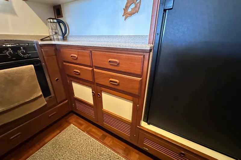 Slide: The Image of 1987 Kadey-Krogen Manatee 36 galley with wooden cabinets and modern appliances. - 37