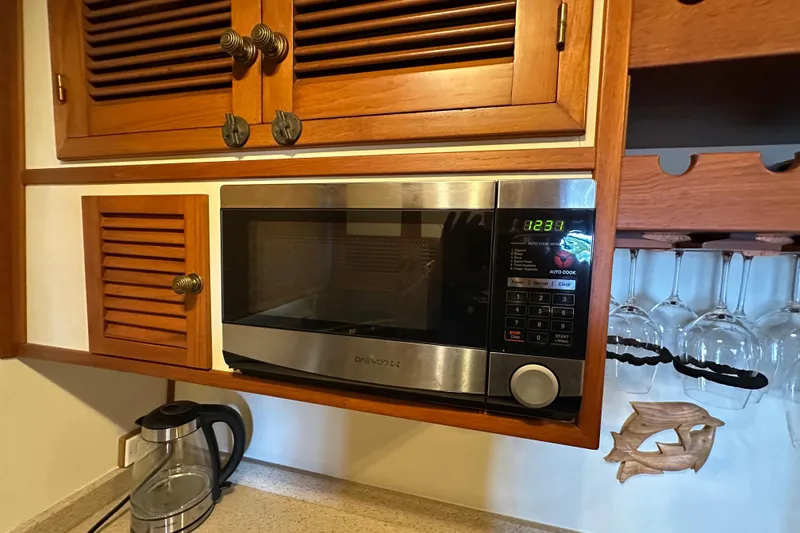 Slide: The Image of Microwave in Kadey-Krogen Manatee 36 yacht kitchen, 1987 model, with wooden cabinets. - 39