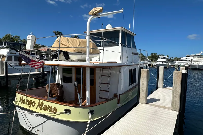 Slide: The Image of 1987 Kadey-Krogen Manatee 36 docked at marina under clear blue sky. - 4