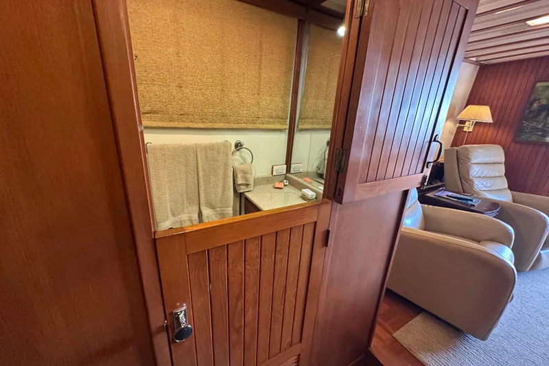Slide: The Image of Interior of 1987 Kadey-Krogen Manatee 36, featuring wooden cabinetry and cozy seating area. - 43