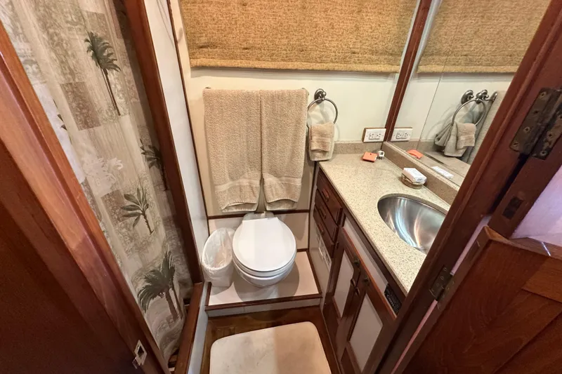 Slide: The Image of Compact bathroom in 1987 Kadey-Krogen Manatee 36 yacht with sink, toilet, and storage. - 44