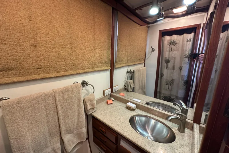 Slide: The Image of Kadey-Krogen Manatee 36 bathroom, 1987 model, featuring sink, towels, and shower curtain. - 45