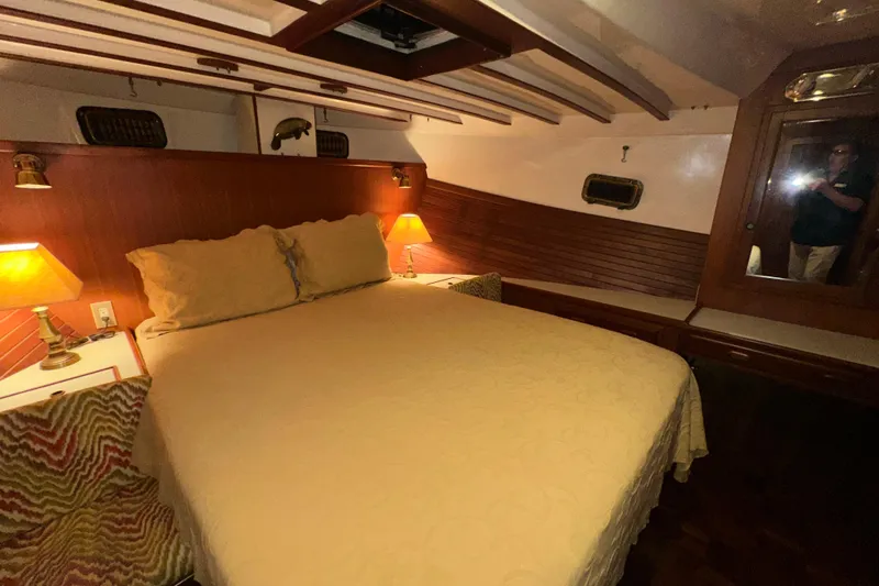 Slide: The Image of Cozy bedroom interior of 1987 Kadey-Krogen Manatee 36 yacht with warm lighting. - 48